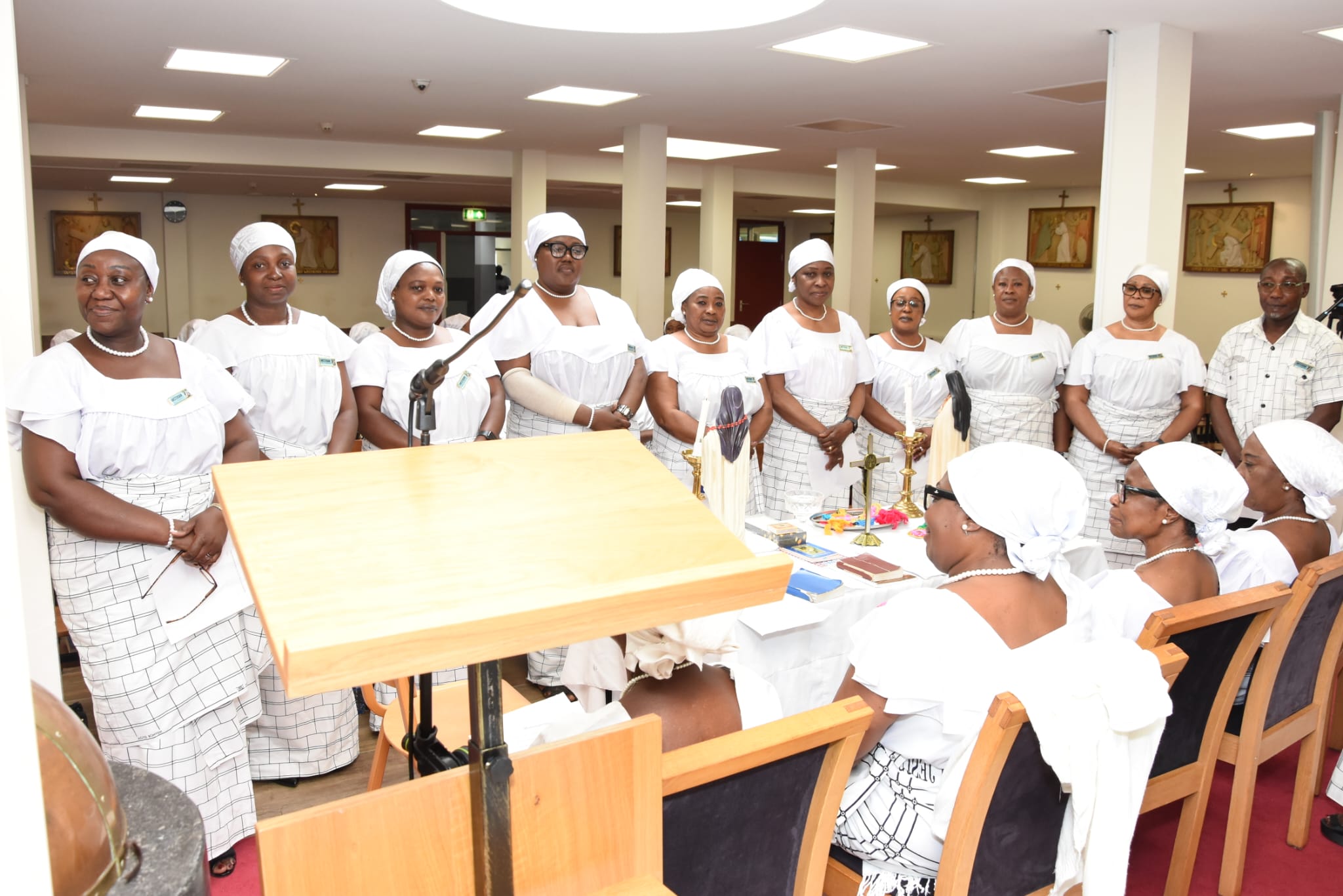 Newly installed executives of St. Teresa’s Society Amsterdam standing before the installation officers